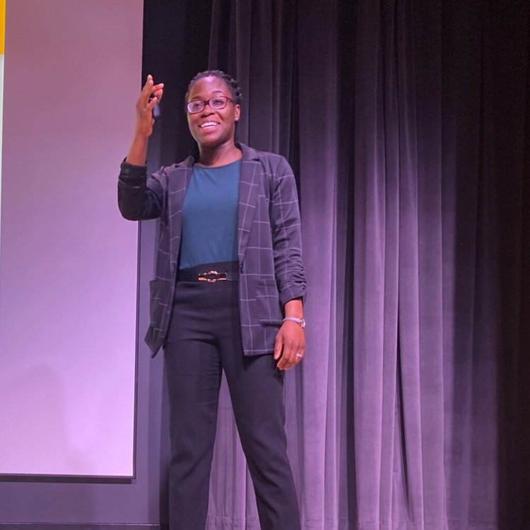 Addressing a full auditorium during a keynote on career readiness for students and families.